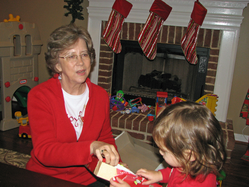 Gloria helping open presents.